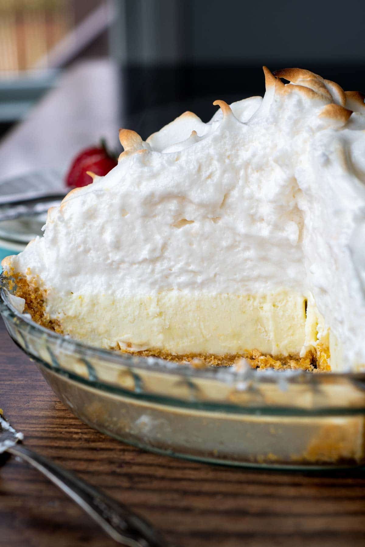 interior view of a whole frozen lemon meringue pie sliced open with an almond flour pie crust.