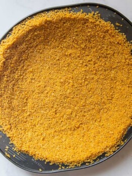 overhead shot of unbaked chex crust in pie dish
