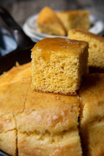 a piece of cornbread sitting on top of ones in an iron skillet