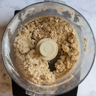 overhead food processor with mixed together oat topping