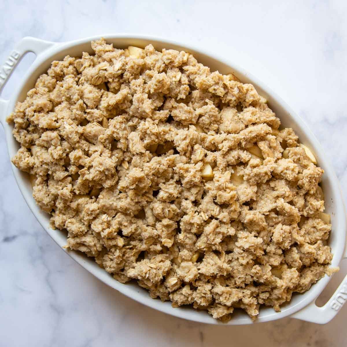 unbaked apple crisp with crumble topping on it.