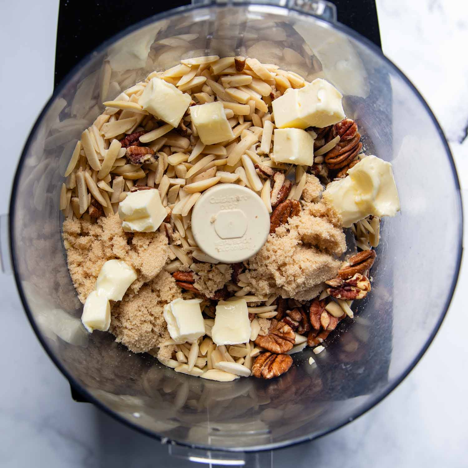 the nuts with softened butter and sugar in a food processor.