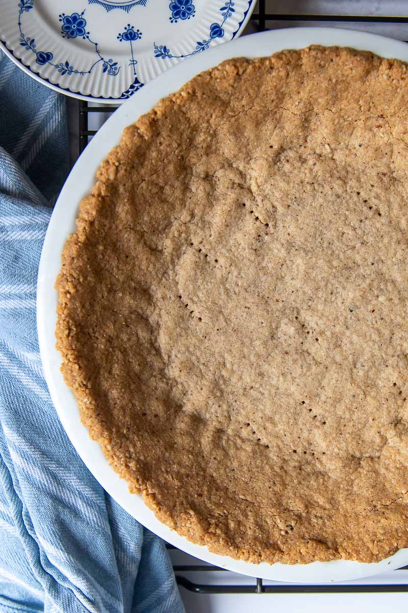overhead of pie crust made from pecans in a pie plate