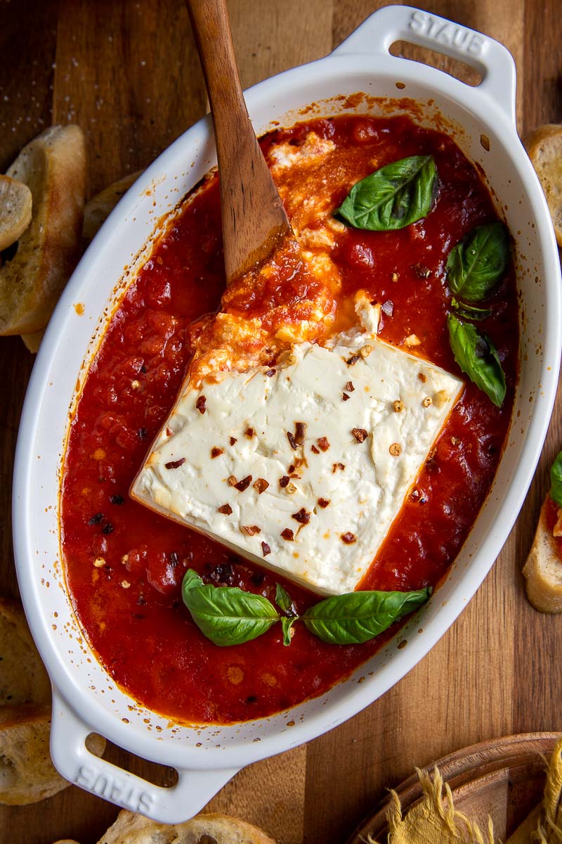 overhead shot of baked feta in a small dish with marinara