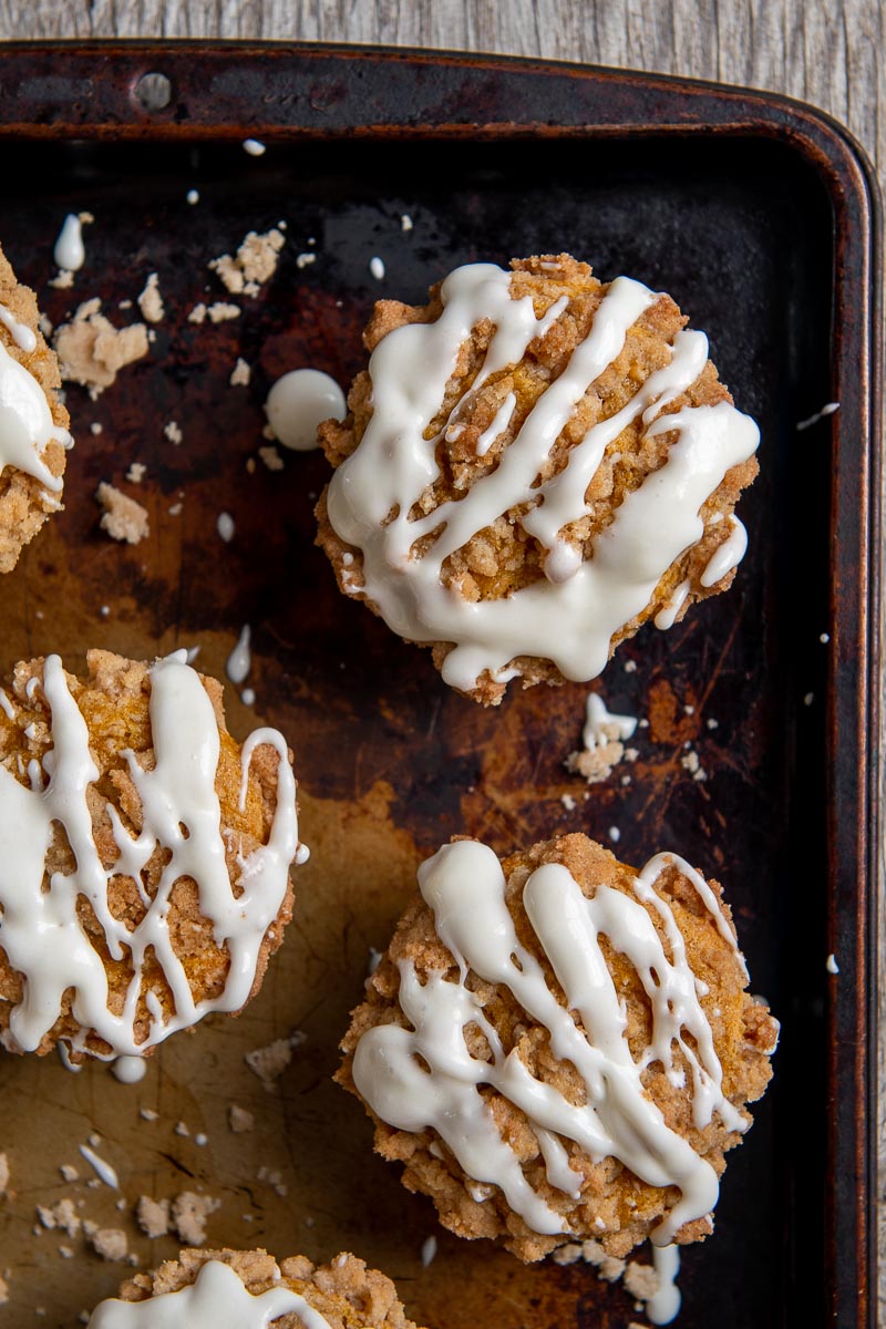overhead shot of pumpkin muffins with cream cheese glaze drizzled over top