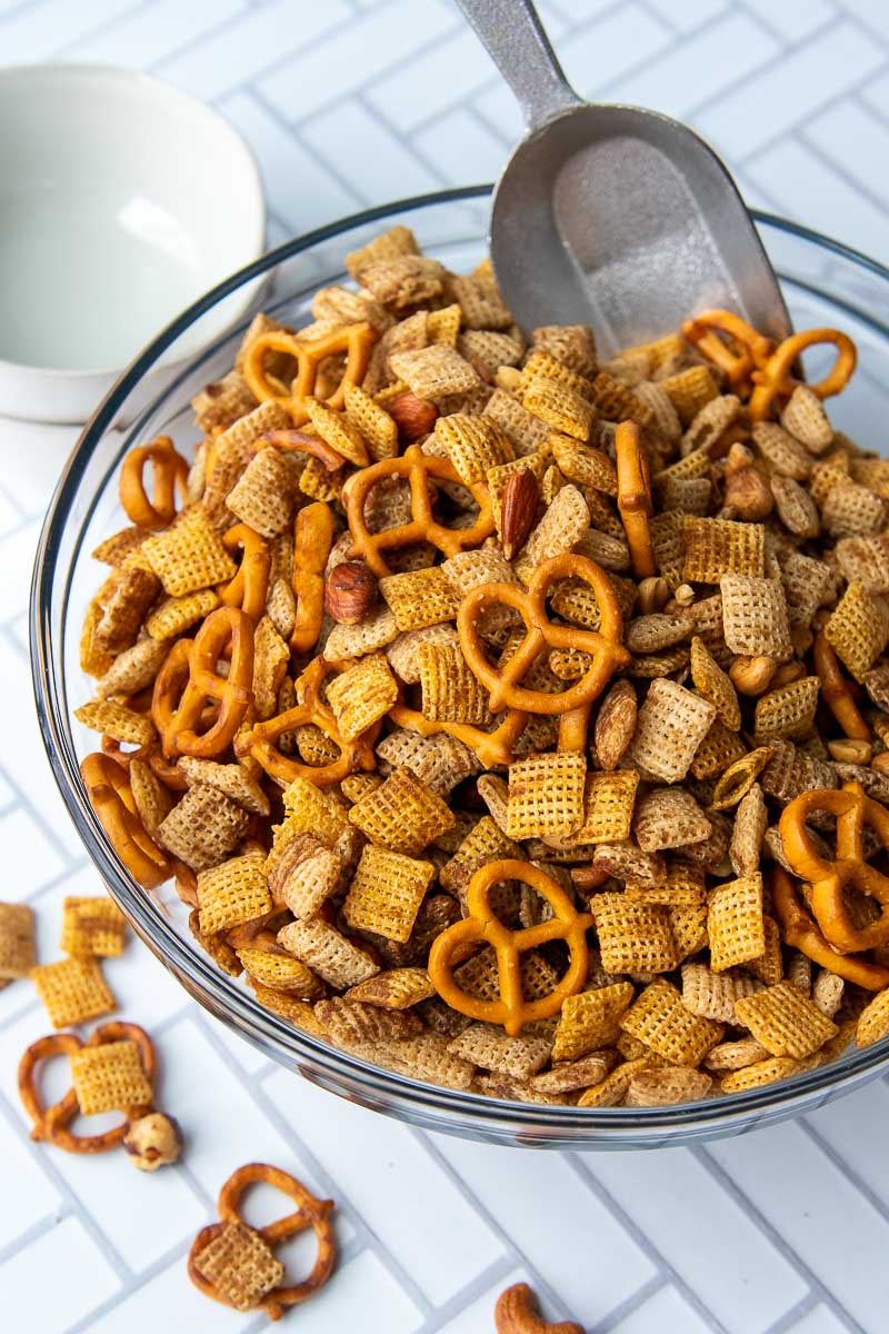 overhead of large bowl of chex mix with a serving scoop inside