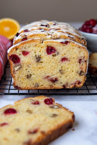 gluten free cranberry bread sliced and facing straight out on a cooling rack