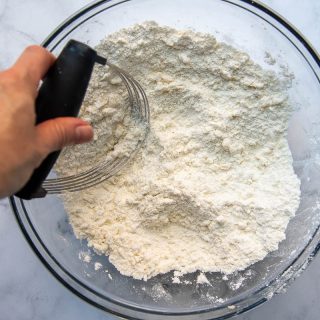 a pastry blender mixing butter into flour
