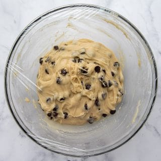 bowl of cookie dough covered with plastic wrap