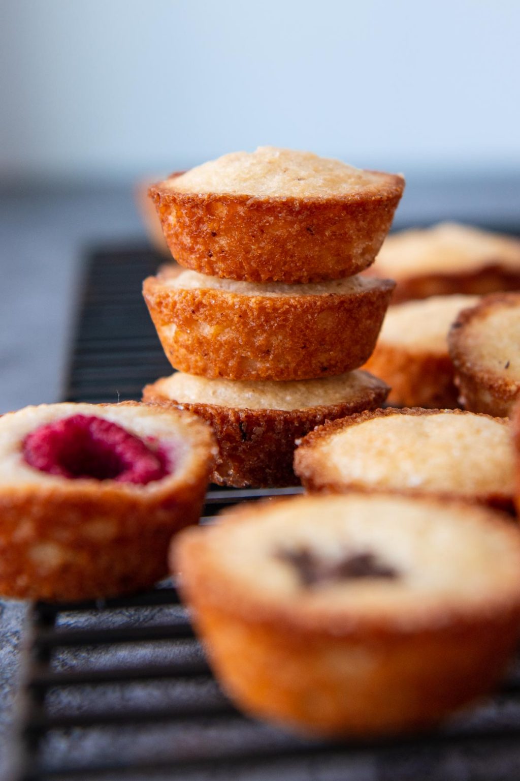 a stack of three financiers on a wire cooling rack