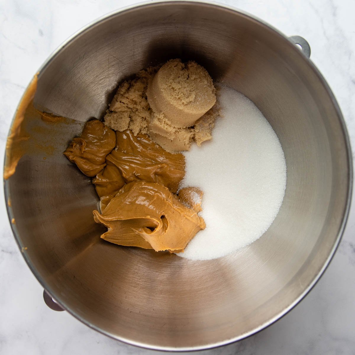 peanut butter and sugars in a mixing bowl.