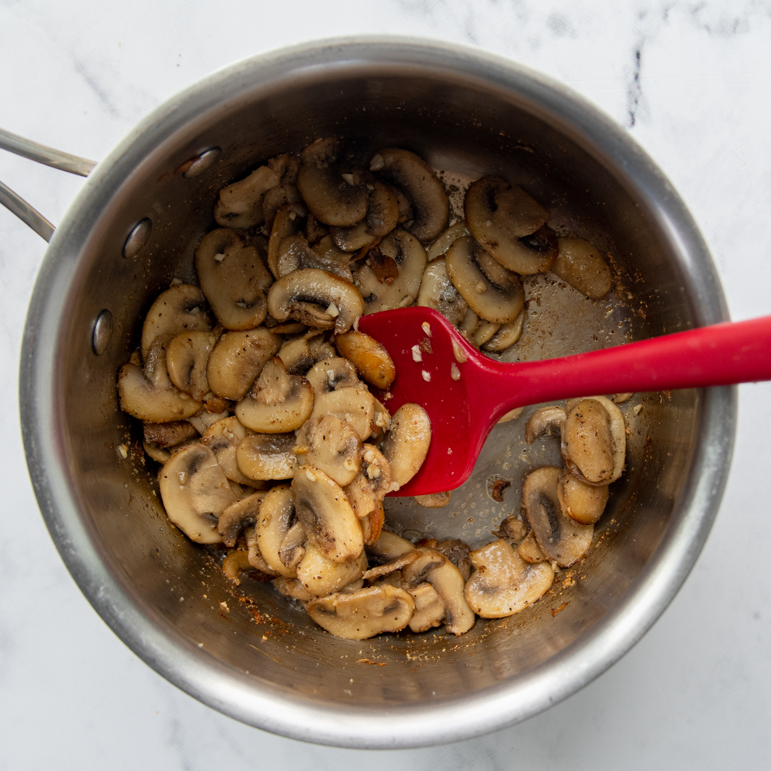 mushrooms cooking in a small saucepan.