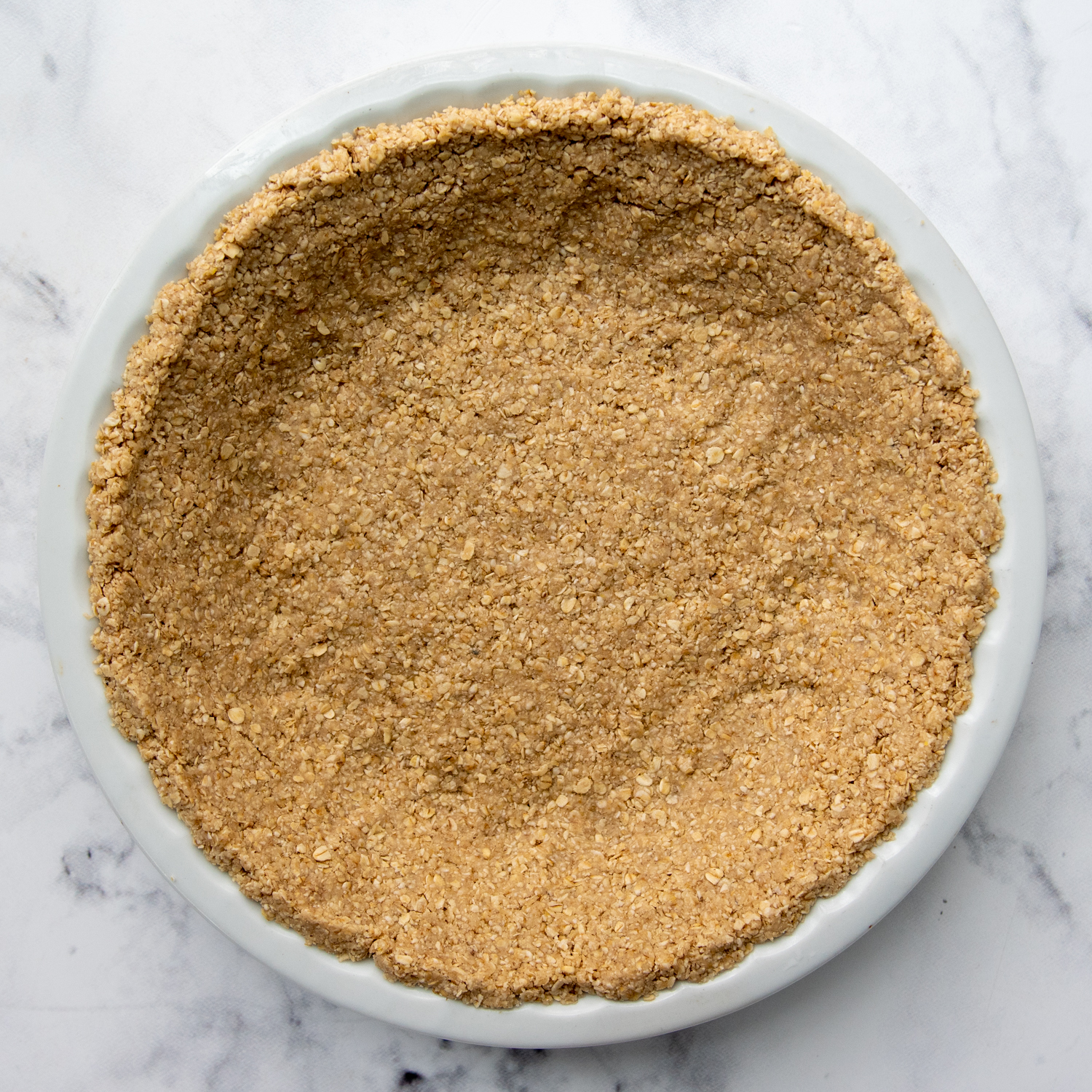 the oatmeal crust pressed into a pie plate.