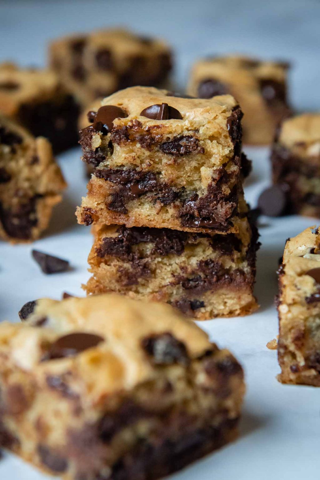 a stack of two blondies with chocolate chips and cut bars around