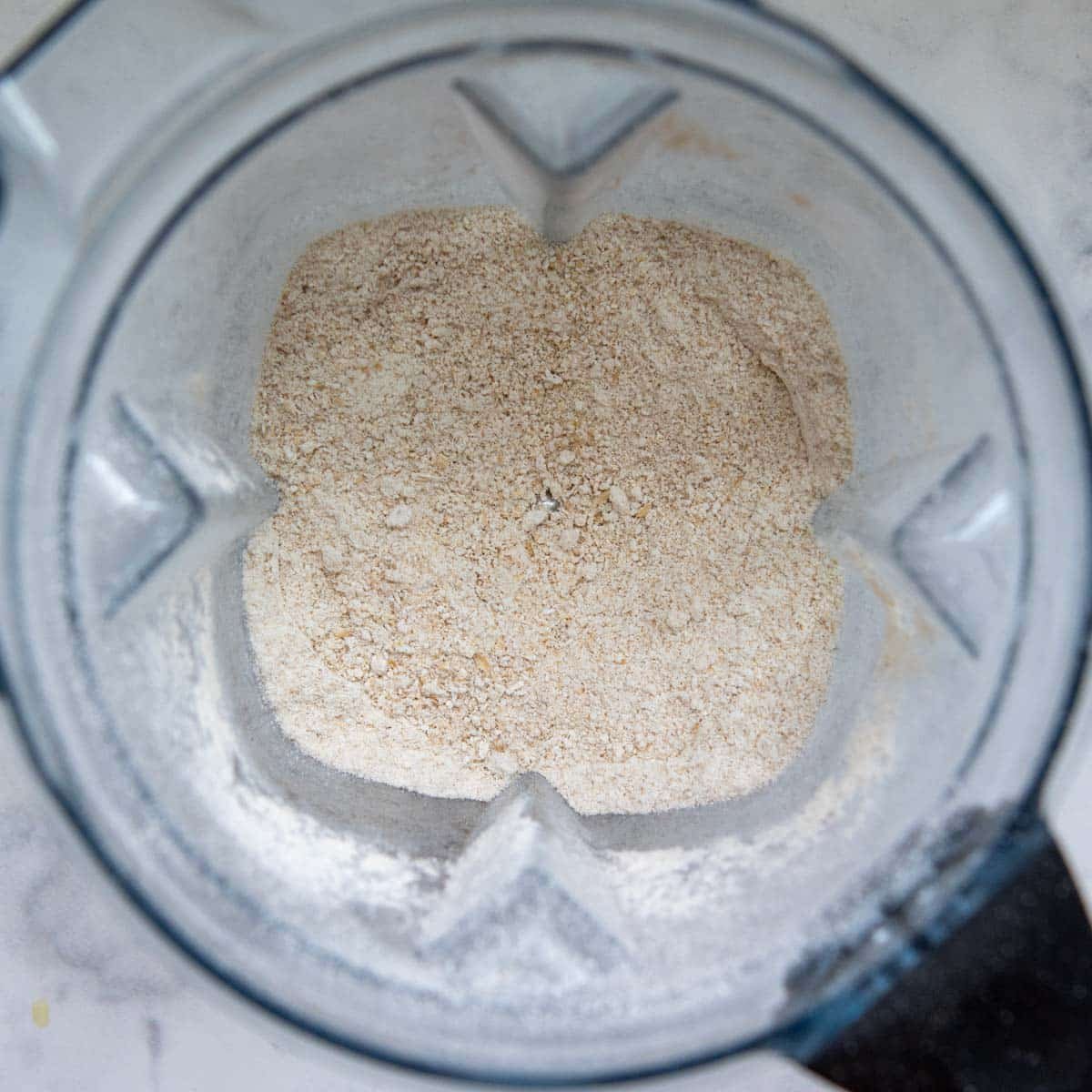 oats blended into oat flour in a blender.