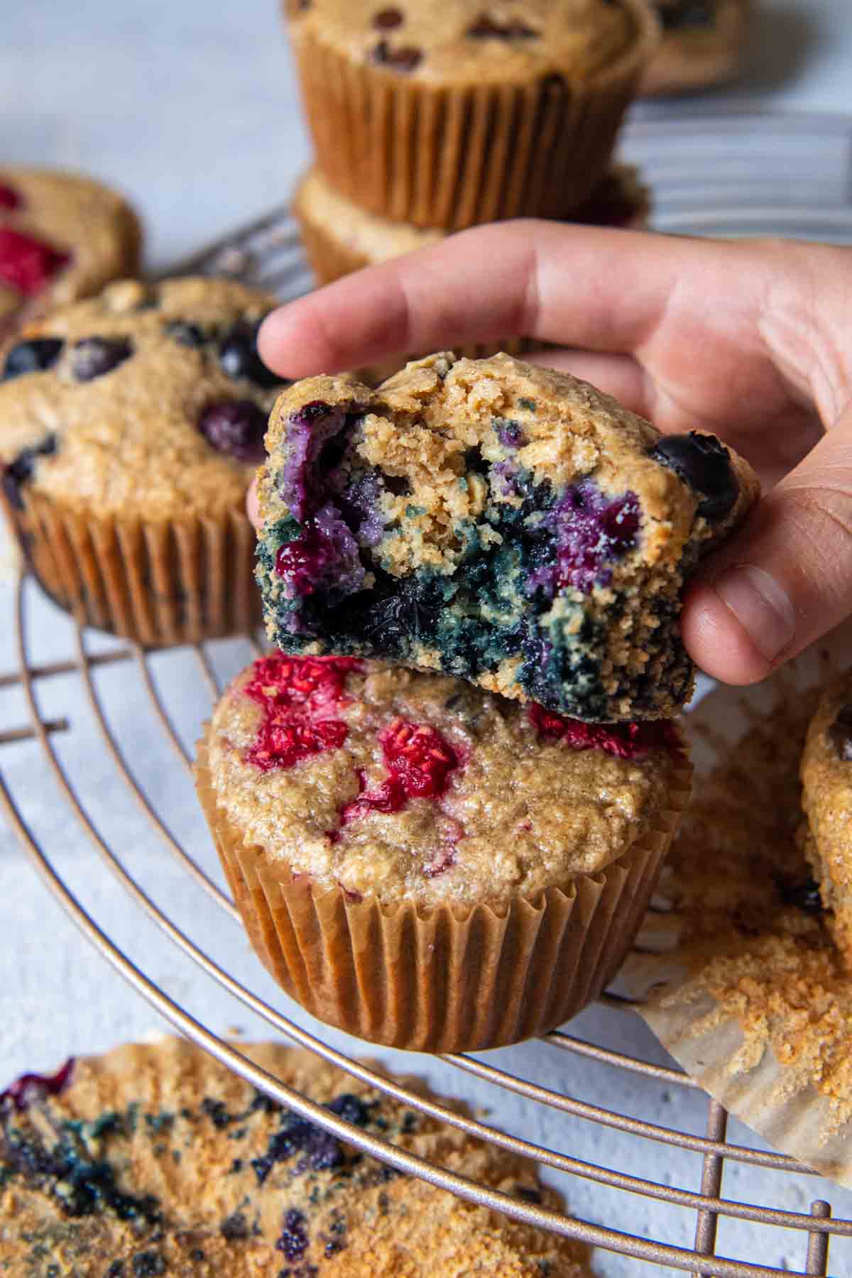 a blueberry muffin bitten into and held up