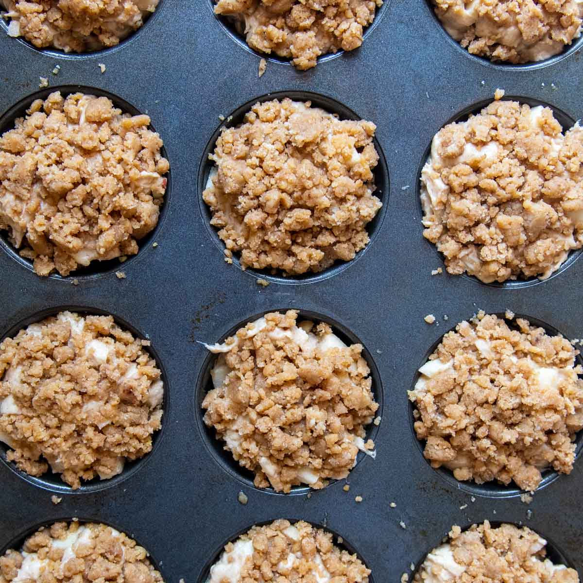 unbaked gluten-free apple muffins with streusel on top
