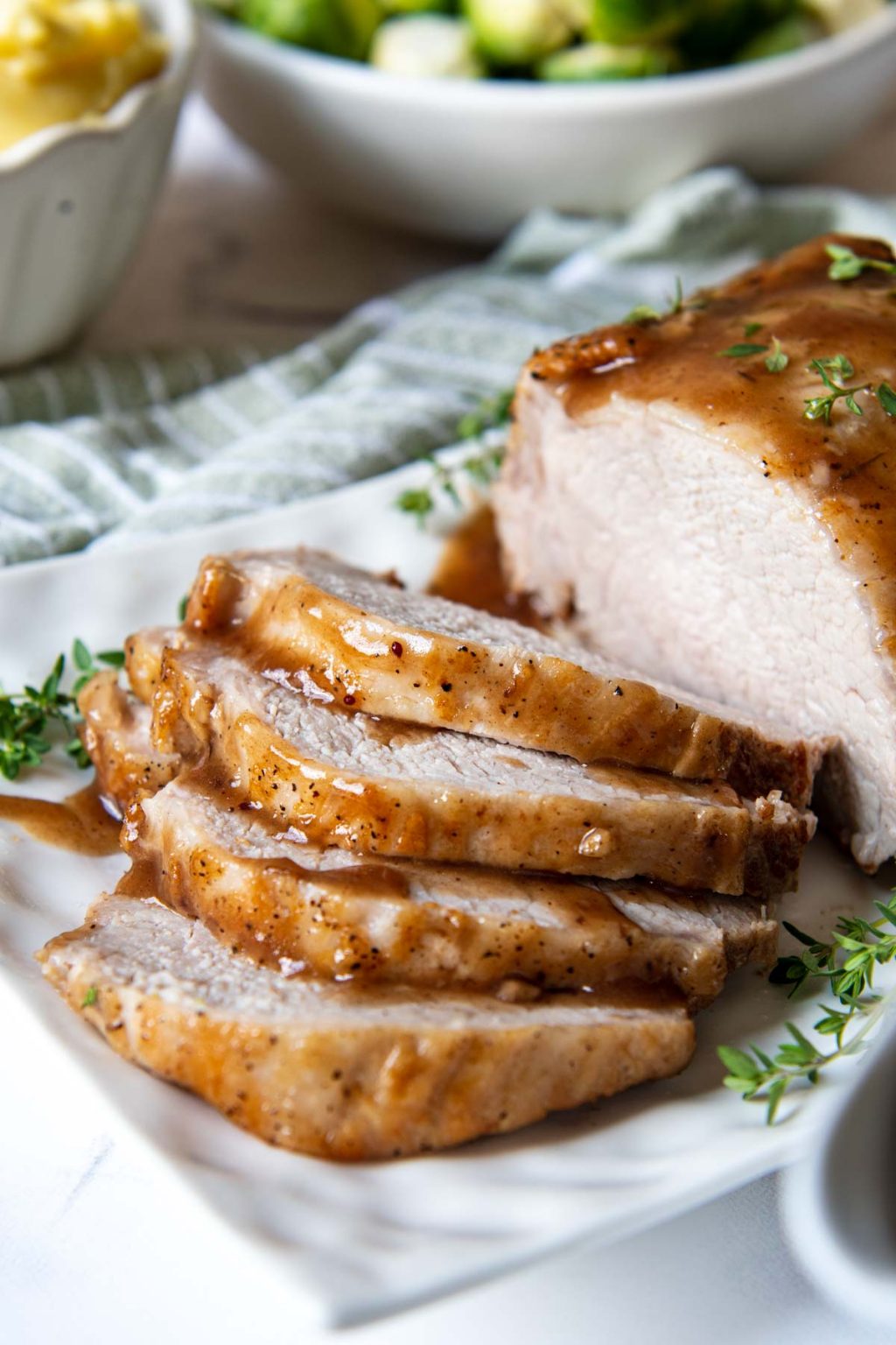 slices of pork roast close up on a white platter