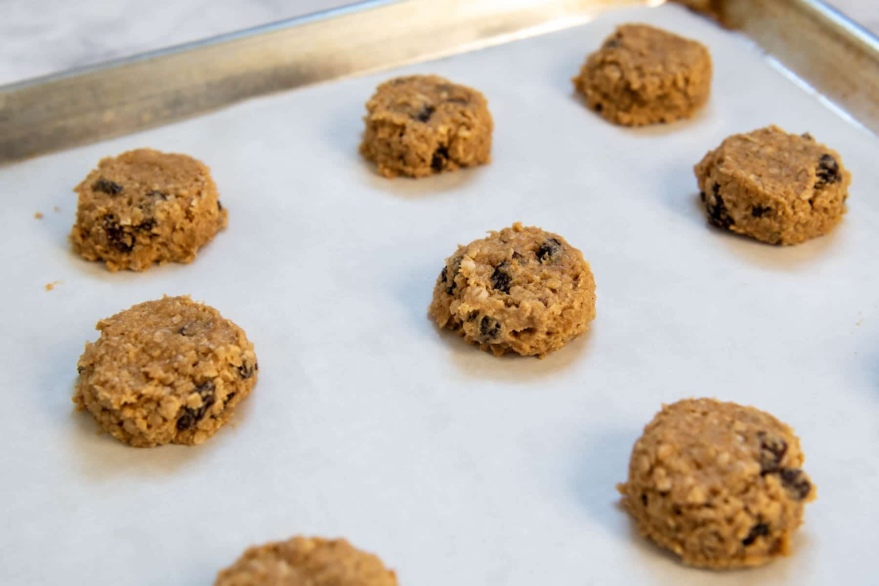 unbaked cookie dough on a cookie sheet