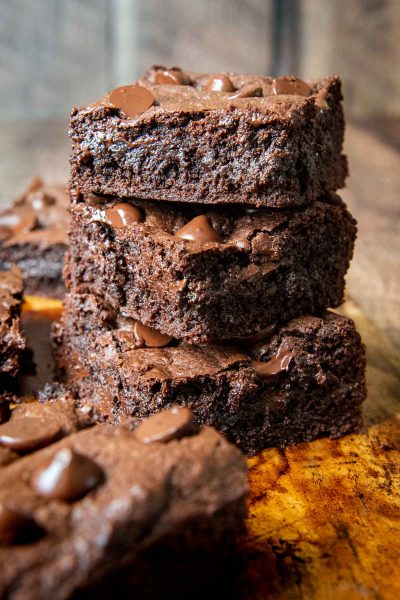 a stack of oat flour brownies on a brown board