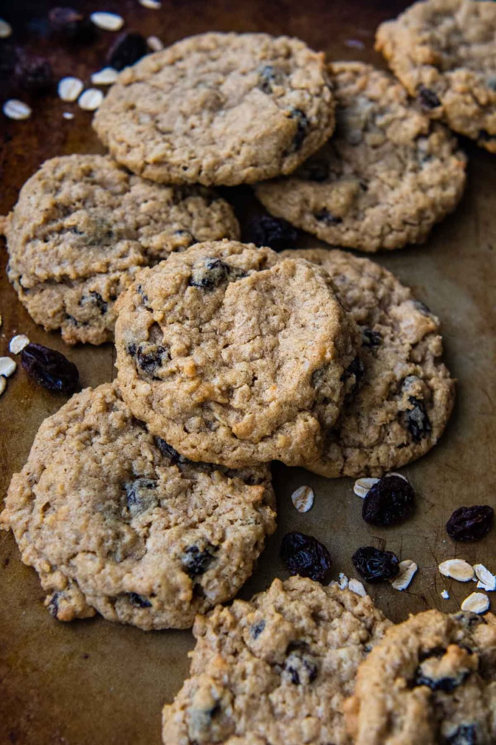 a close up of a gluten-free oatmeal raisin cookies with other cookies underneath it