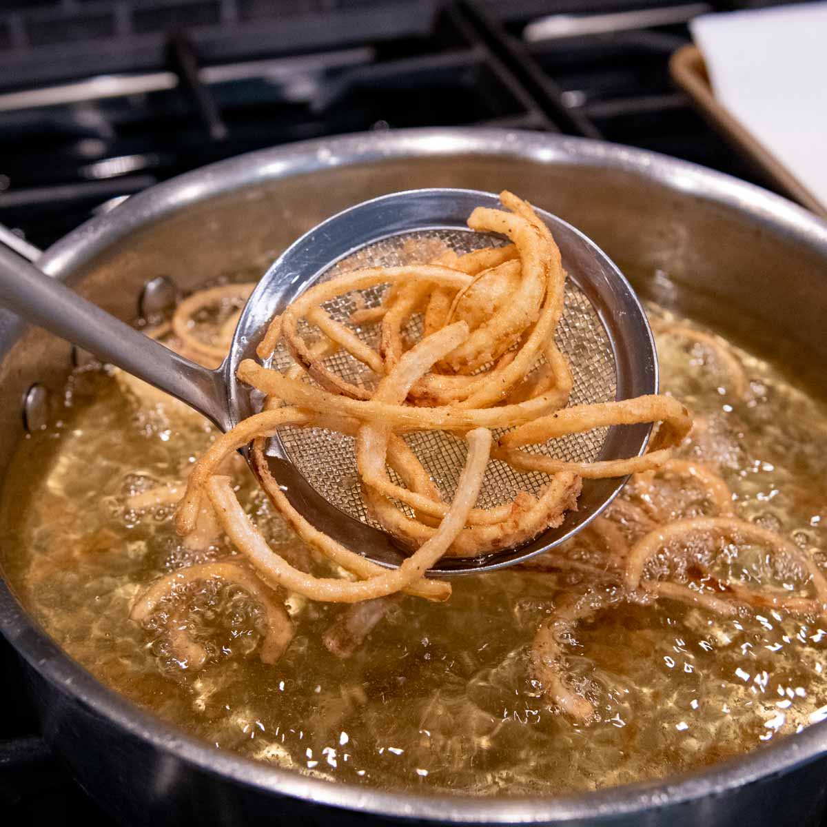 french fried onions coming out of oil.