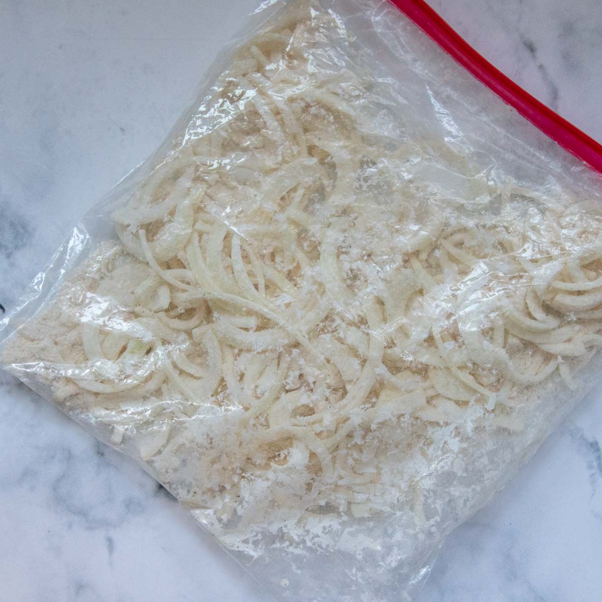 a bag of flour coated onions before frying