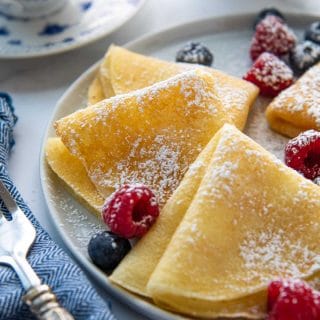 close up of folded plates with berries scattered around