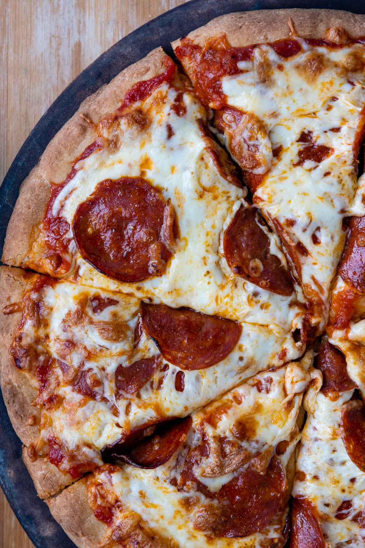 overhead shot of pepperoni pizza sliced