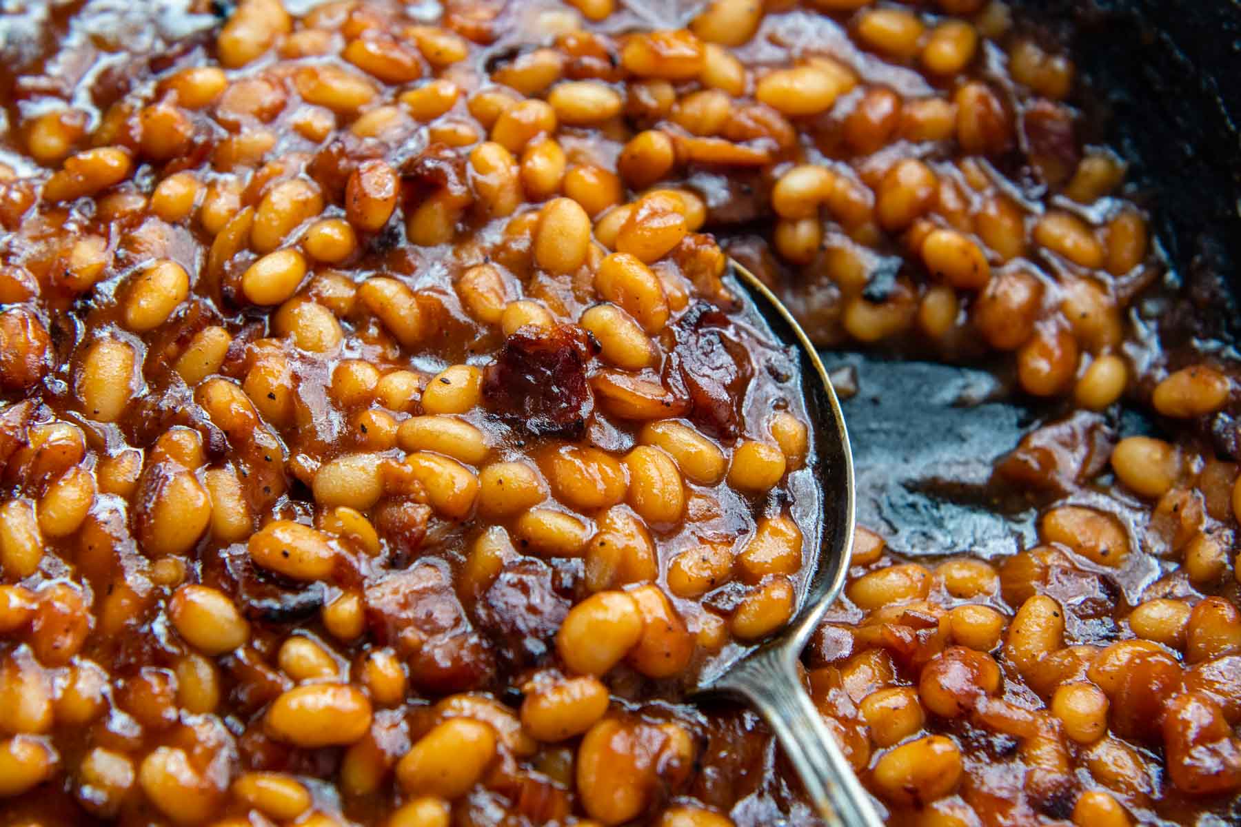 another image of a spoon lifting up baked beans.