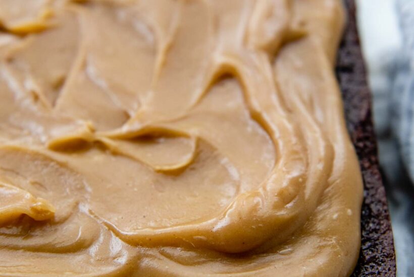 close up of peanut butter frosting on a chocolate cake.