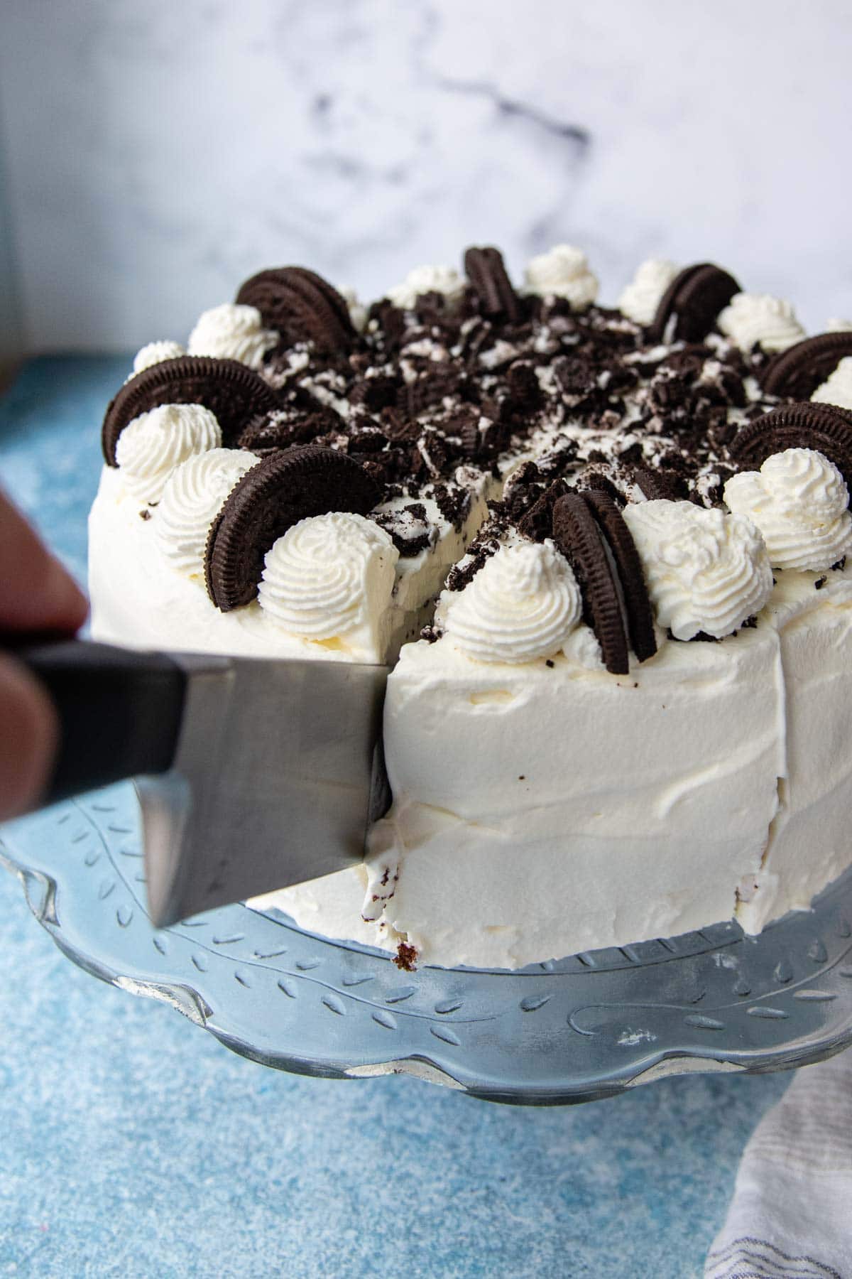 a large knife slicing into an ice cream cake.