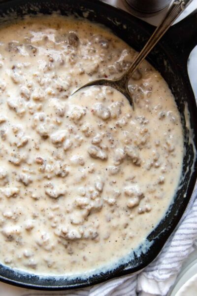 overhead shot of sausage gravy in a cast iron skillet.