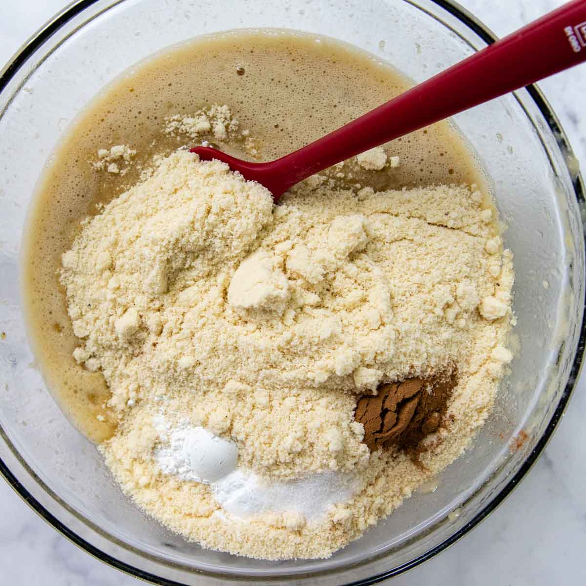 dry ingredients mixed in the bowl with the mashed bananas.