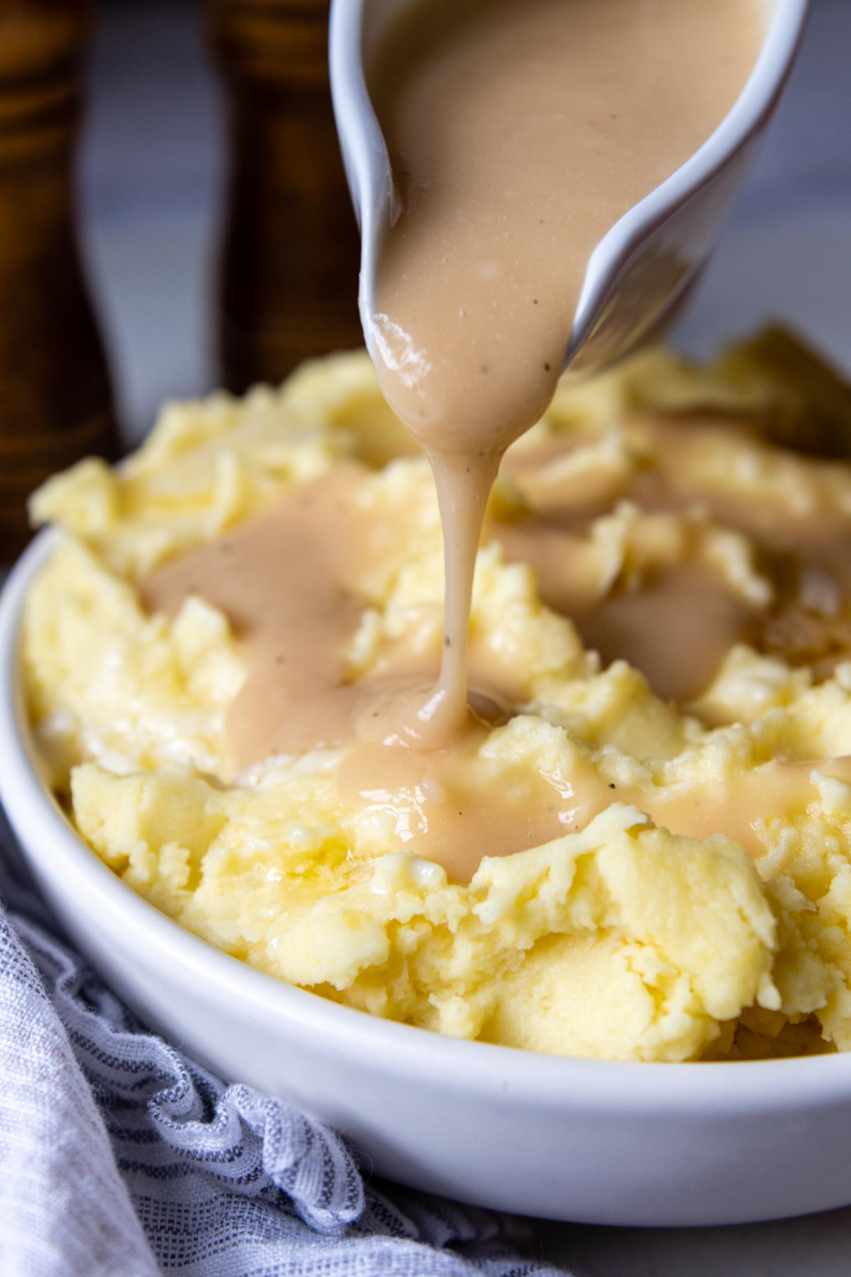 gluten free gravy being poured over mashed potatoes.