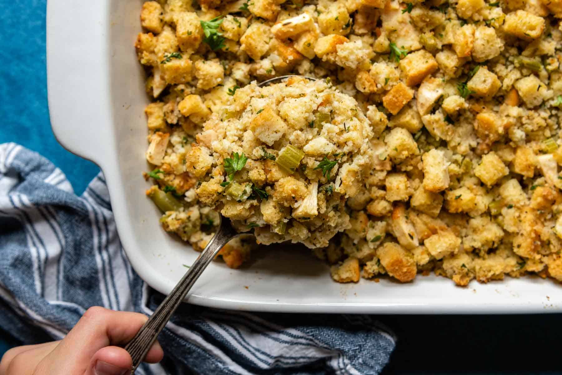 a spoon lifting out a serving of stuffing.