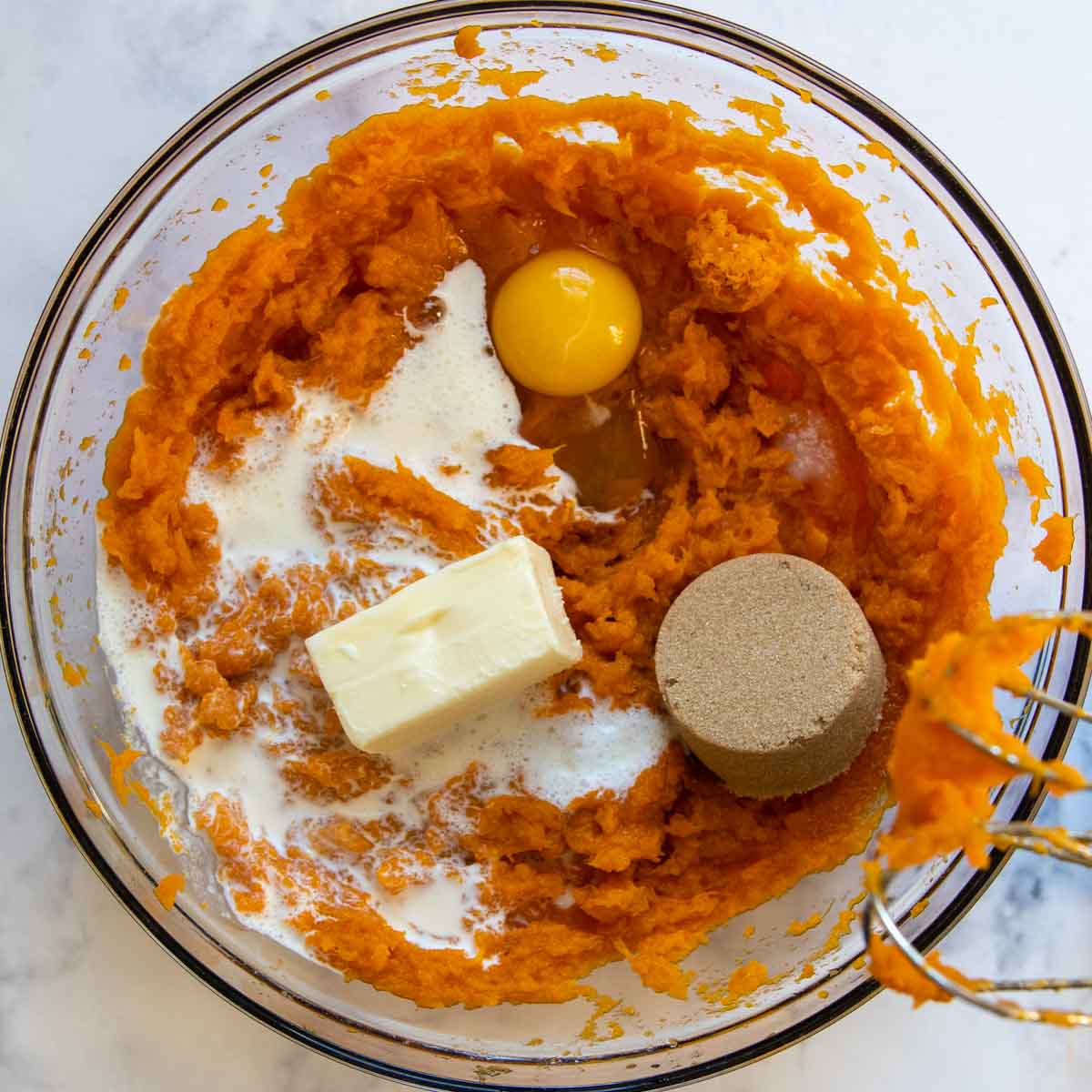 egg, cream, brown sugar, and butter added to the mashed sweet potatoes.