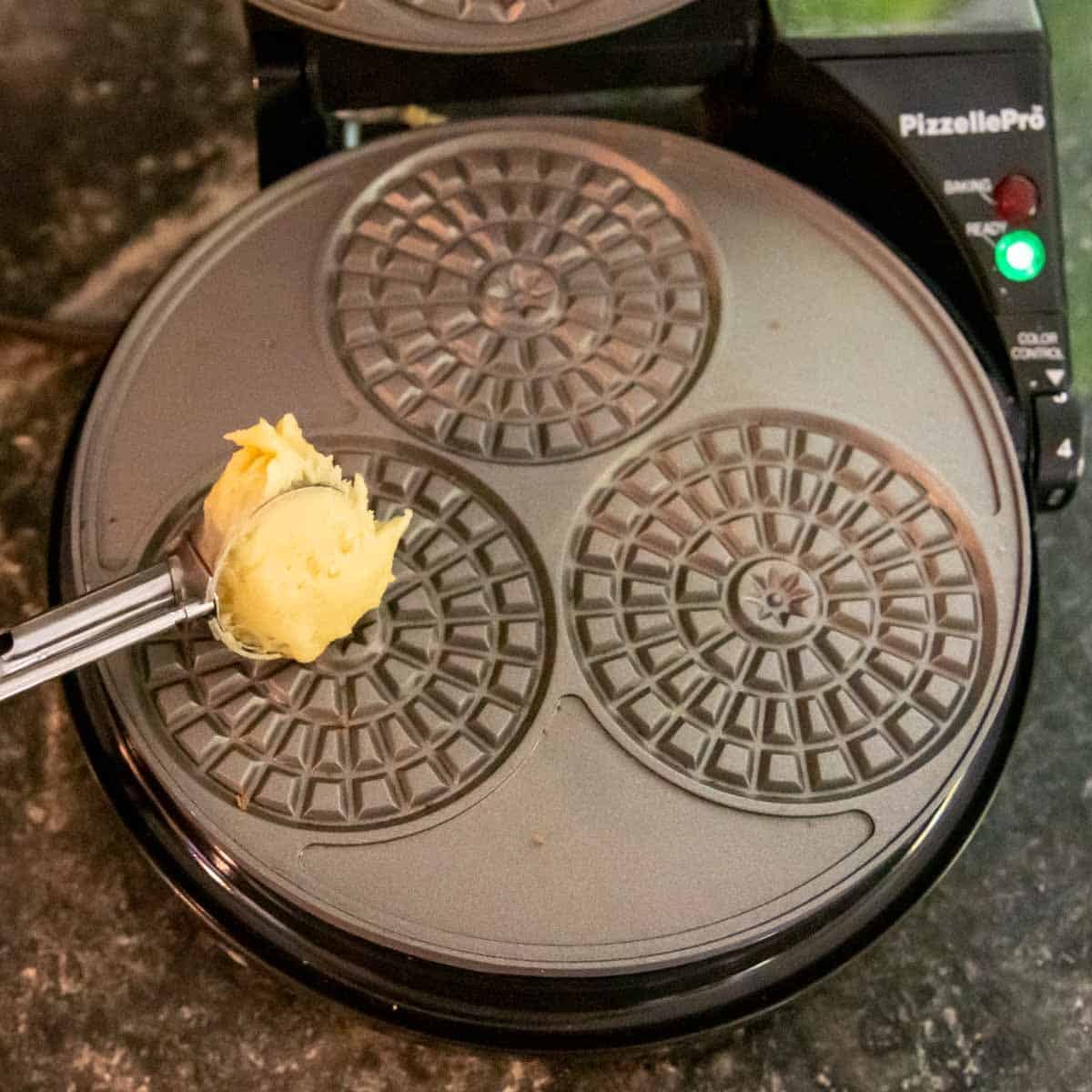 batter going on a pizzelle iron.