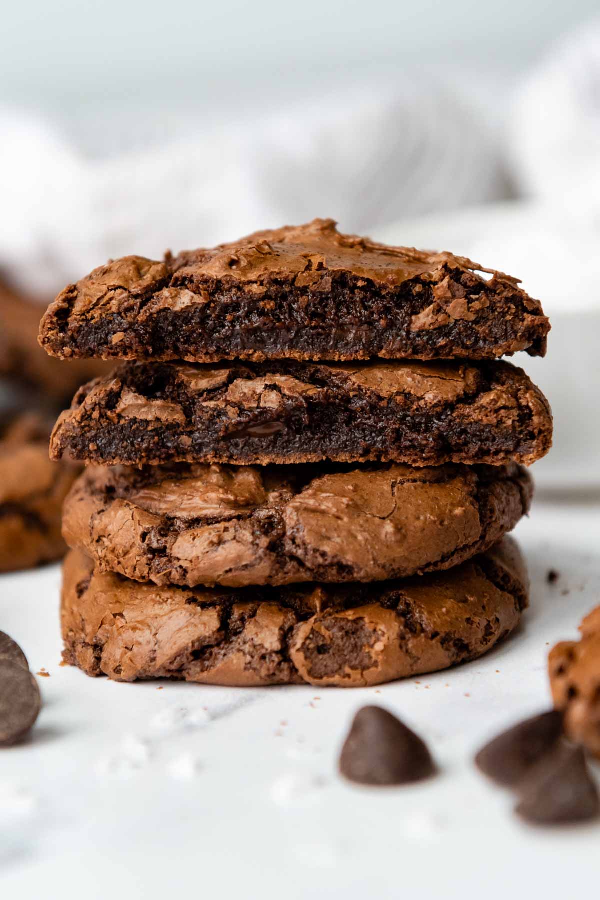 a stack of gluten free chocolate cookies with the top two broken open.