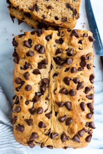 overhead view of gluten free peanut butter bread with chocolate chips on a white surface