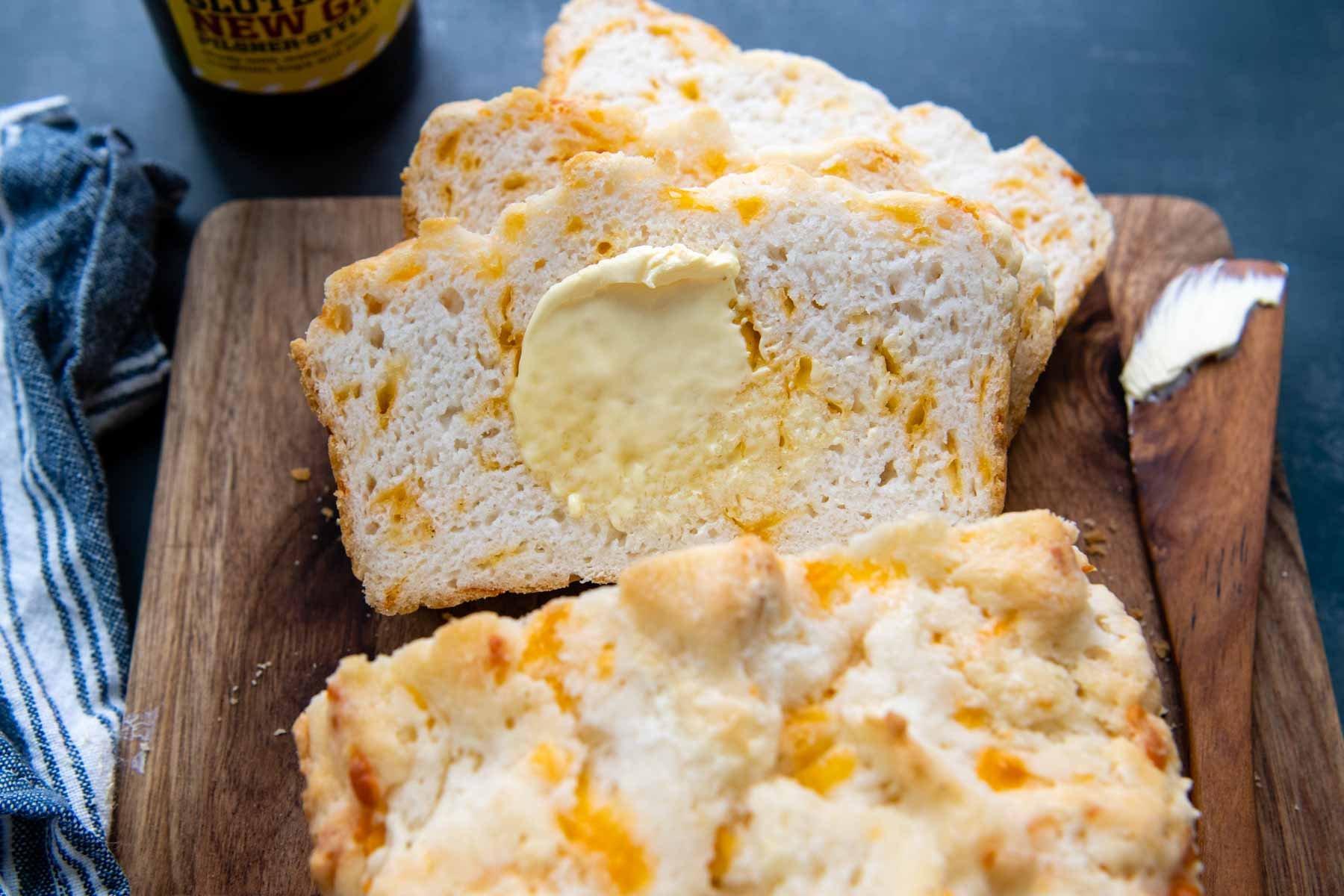 sliced beer bread with melting butter spread on.