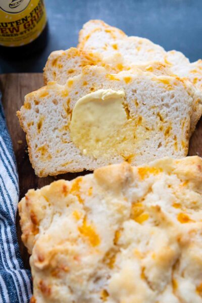 sliced gluten free beer bread with melting butter spread on.