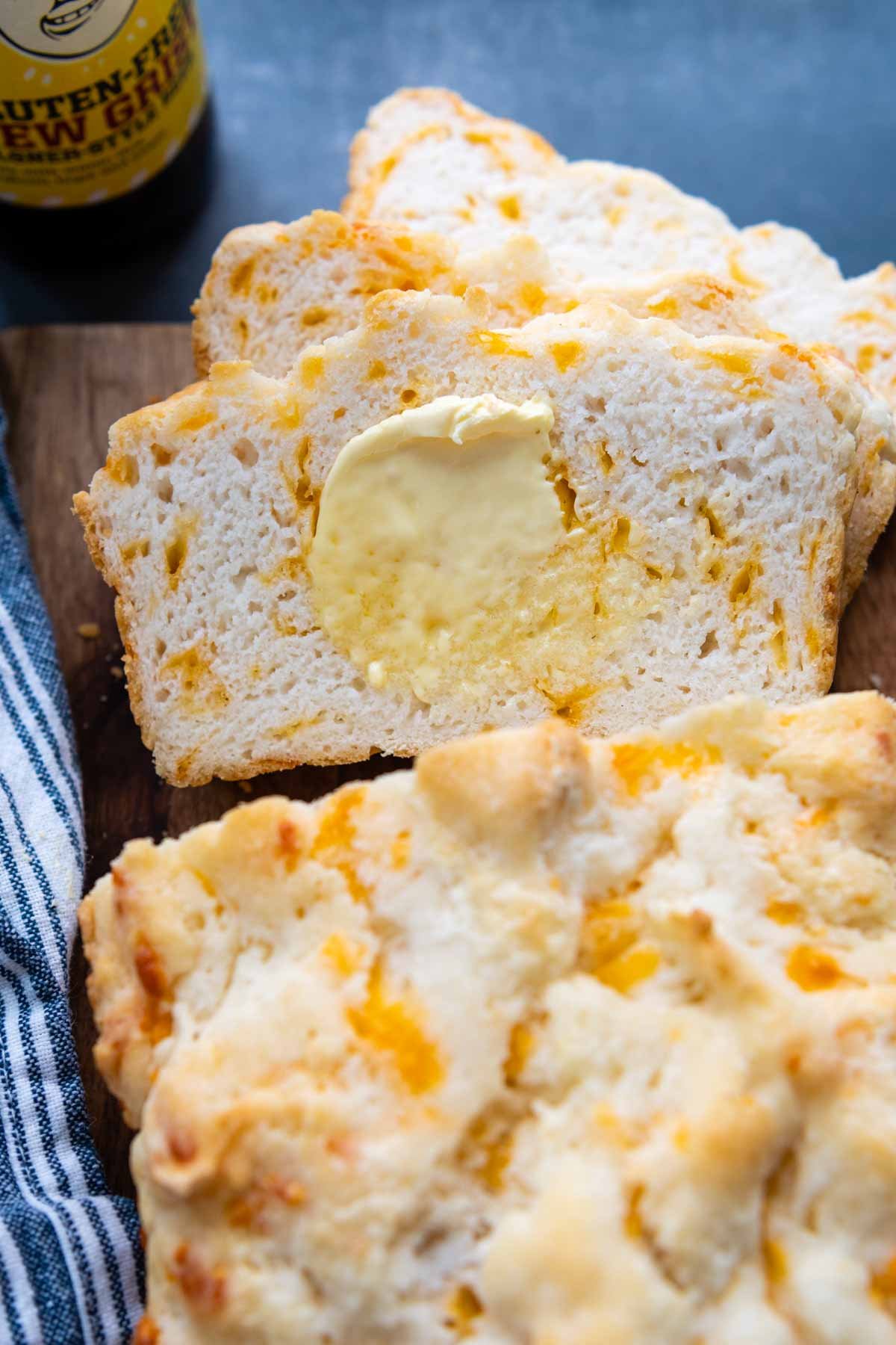 sliced gluten free beer bread with melting butter spread on.