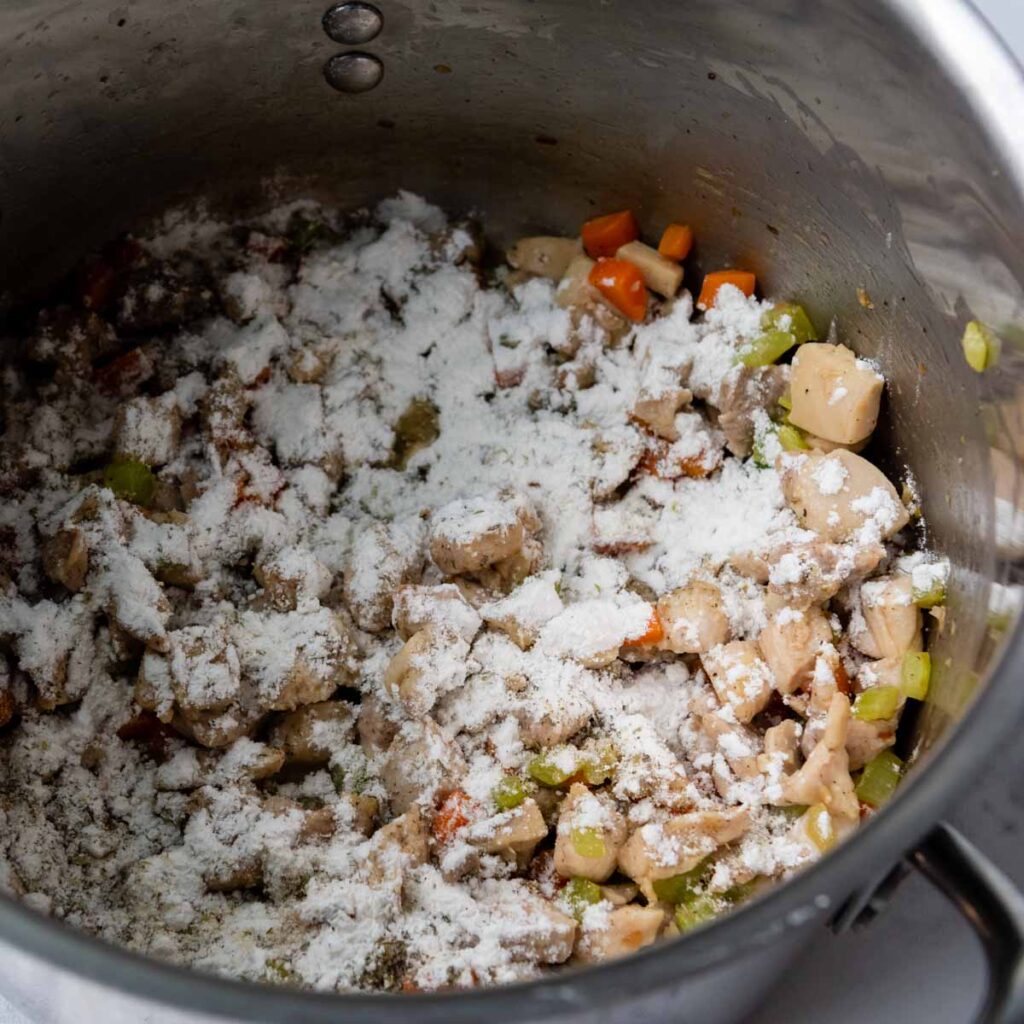 sprinkle flour over veggies and chicken.