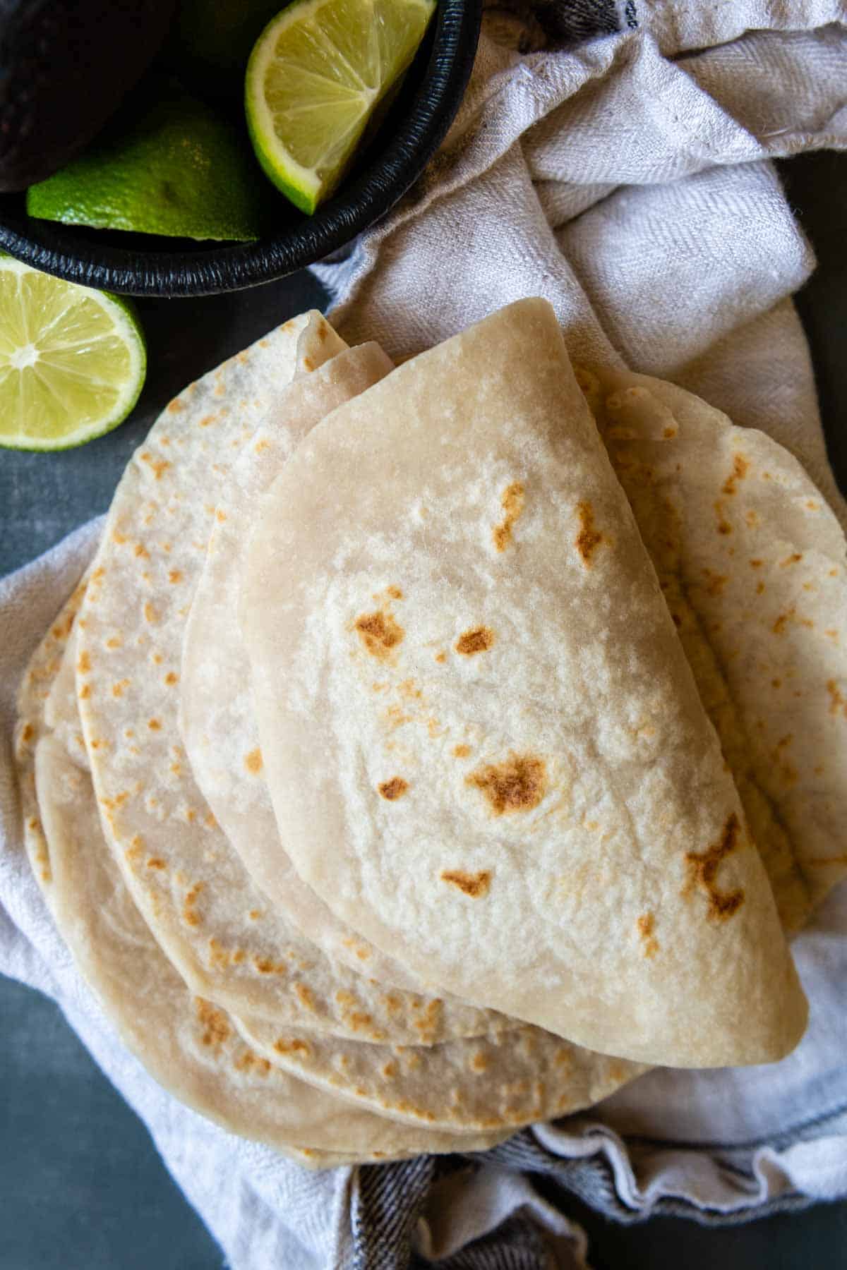 folded over tortillas with a lime nearby.