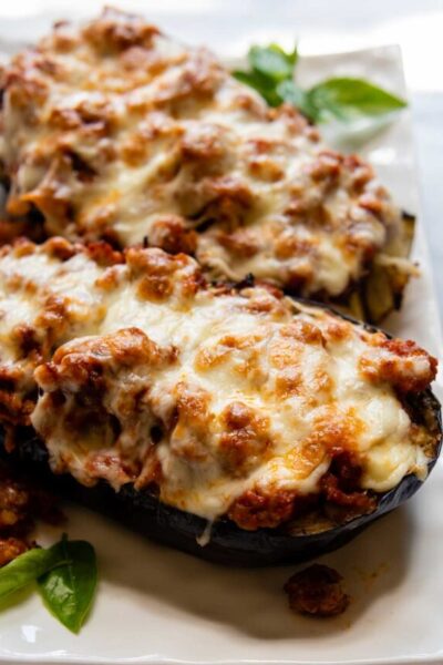 close up of baked eggplant on a white dish.