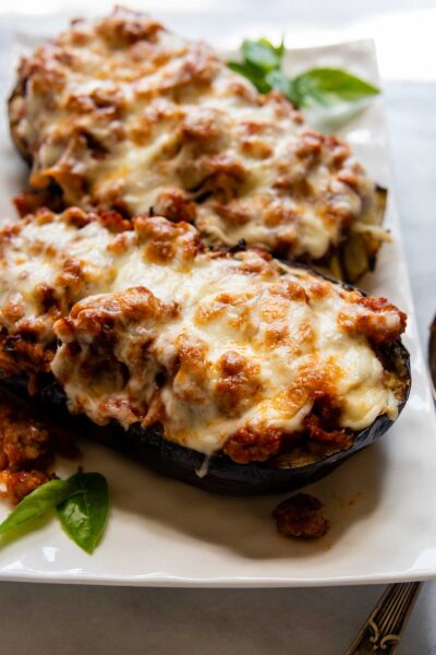 close up of baked eggplant on a white dish.