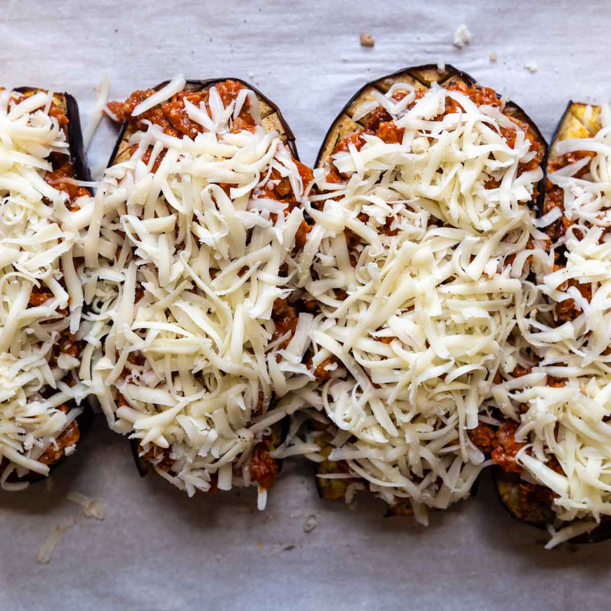 unbaked eggplant topped with cheese.