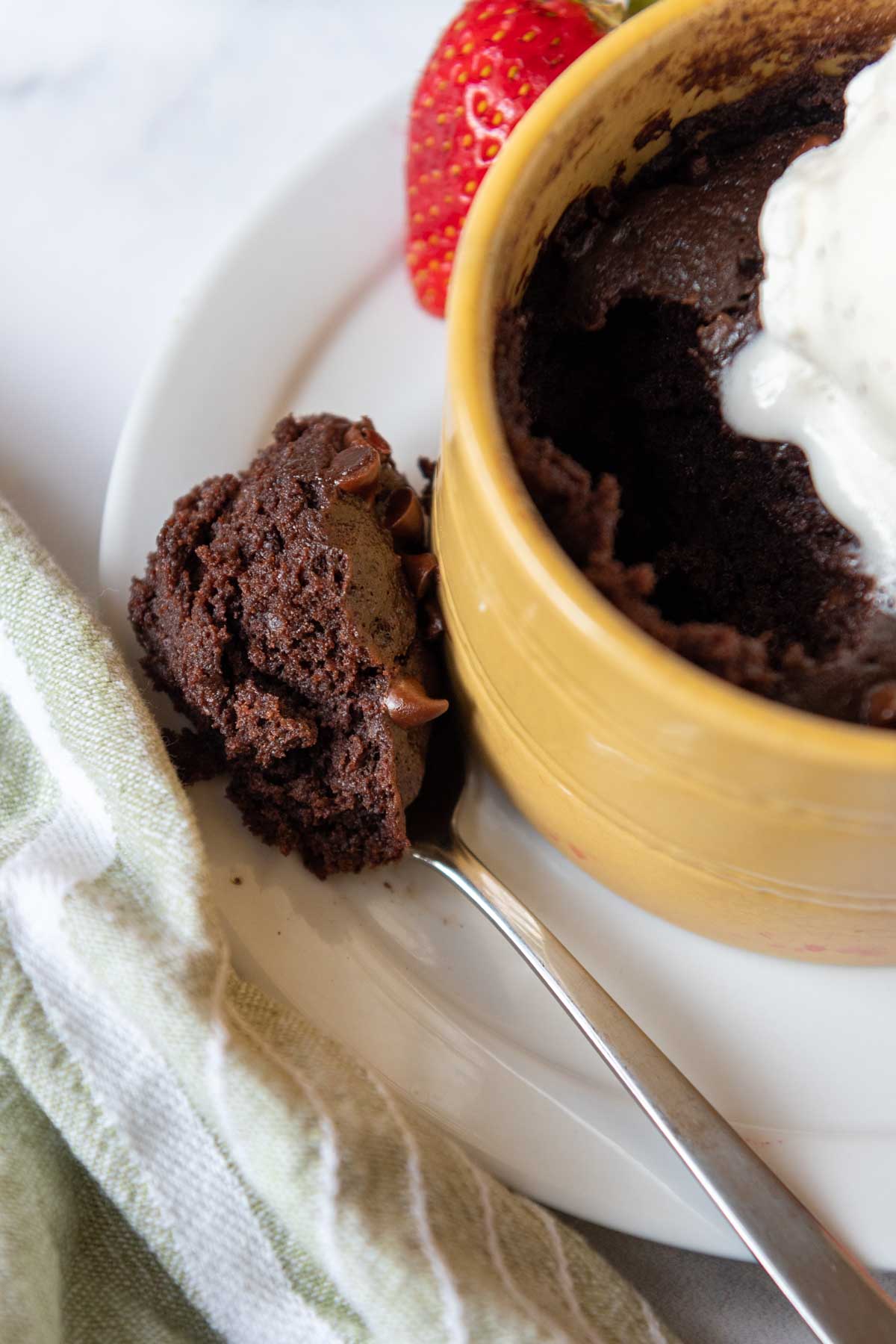 a spoon of brownie resting on a dish.