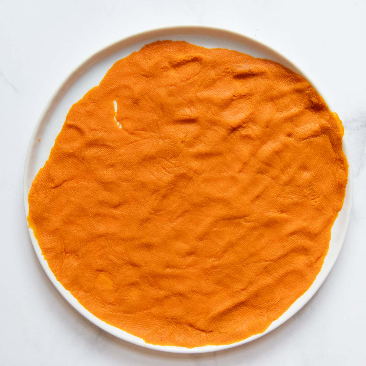 canned pumpkin spread on a white plate.